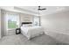 Spacious main bedroom with tray ceiling, large windows, plush carpet, and neutral decor at 3839 White Ibis Rd, Lakeland, FL 33811