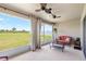 Inviting screened porch with ceiling fans, comfortable seating, and a serene view of the backyard at 3839 White Ibis Rd, Lakeland, FL 33811