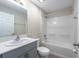 Clean bathroom featuring a vanity with sink, toilet, and a shower-tub combination at 5933 Slate Rock Dr, Lakeland, FL 33811
