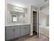 Bright bathroom features double sinks, a large mirror, and a walk-in shower, plus storage at 5933 Slate Rock Dr, Lakeland, FL 33811