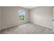 Bright bedroom with carpet, neutral walls, and a window with natural light at 5933 Slate Rock Dr, Lakeland, FL 33811