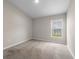 Bright, carpeted bedroom features neutral walls and a window view to the outside at 5933 Slate Rock Dr, Lakeland, FL 33811
