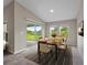 Bright dining room with sliding door, neutral decor and sleek wooden table set for six at 5933 Slate Rock Dr, Lakeland, FL 33811