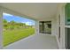 Covered patio offering seamless indoor-outdoor living with views of the lush green backyard at 5933 Slate Rock Dr, Lakeland, FL 33811