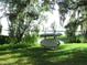 Picturesque backyard featuring lush greenery and a convenient kayak storage rack at 206 Samantha Ave, Auburndale, FL 33823