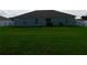 Spacious backyard featuring lush green lawn and privacy fence at 206 Samantha Ave, Auburndale, FL 33823