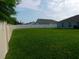 Large backyard with green grass and white vinyl fence providing privacy at 206 Samantha Ave, Auburndale, FL 33823
