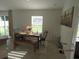 Dining room with a wooden table, bench, and chairs with natural light from a window at 206 Samantha Ave, Auburndale, FL 33823