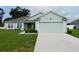 Charming one-story home boasts a manicured lawn and attached two-car garage at 206 Samantha Ave, Auburndale, FL 33823