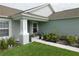 The home has a lovely covered front porch with decorative plants and bench seating at 206 Samantha Ave, Auburndale, FL 33823