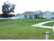 Beautiful one-story home showcasing a lush green lawn and a two-car garage at 206 Samantha Ave, Auburndale, FL 33823