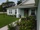 The home has a welcoming walkway, lush lawn and landscaping with beautiful accents at 206 Samantha Ave, Auburndale, FL 33823