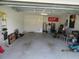 Spacious two-car garage featuring ample storage, a clean concrete floor, and functional organization at 206 Samantha Ave, Auburndale, FL 33823