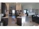 Open-concept kitchen with modern appliances and a spacious island, flowing into the living area at 206 Samantha Ave, Auburndale, FL 33823
