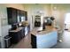 Modern kitchen features stainless steel appliances, breakfast bar, and dark cabinets at 206 Samantha Ave, Auburndale, FL 33823