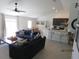 Open concept living area with bar stool seating, a kitchen view and a living room with sofa at 206 Samantha Ave, Auburndale, FL 33823