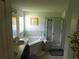 The main bathroom features a soaking tub, step-in shower and decorative accents at 206 Samantha Ave, Auburndale, FL 33823