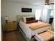The main bedroom features a comfortable king bed, ceiling fan and two side tables at 206 Samantha Ave, Auburndale, FL 33823