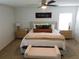 The main bedroom features neutral paint, a ceiling fan and comfortable furnishings at 206 Samantha Ave, Auburndale, FL 33823