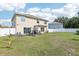 Spacious backyard featuring lush green grass, patio area, and a white fence at 4422 Evergreen Forest Loop, Kissimmee, FL 34758