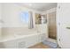 Bright bathroom featuring a garden tub, a tiled glass shower and a decorative geometric rug at 4422 Evergreen Forest Loop, Kissimmee, FL 34758