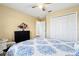 Bedroom with a ceiling fan, white closets, and natural light at 4422 Evergreen Forest Loop, Kissimmee, FL 34758