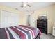 Bedroom featuring neutral walls, carpet and a bed with a multi-colored patterned bedding at 4422 Evergreen Forest Loop, Kissimmee, FL 34758