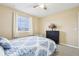 Bedroom with bright natural light, a ceiling fan, and a dark wood dresser at 4422 Evergreen Forest Loop, Kissimmee, FL 34758