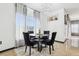 Cozy dining area with stylish black chairs, modern lighting, and natural light from windows at 4422 Evergreen Forest Loop, Kissimmee, FL 34758