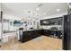 Spacious kitchen with modern black cabinets, stainless steel appliances, open to the living area at 4422 Evergreen Forest Loop, Kissimmee, FL 34758