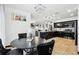 Eat-in kitchen with dark cabinets, stainless appliances, granite countertops, and pendant lighting at 4422 Evergreen Forest Loop, Kissimmee, FL 34758