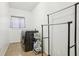 Laundry room equipped with modern washing machine, dryer, and storage for cleaning supplies at 4422 Evergreen Forest Loop, Kissimmee, FL 34758
