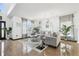 Bright living room boasts tile floors, large windows with stylish curtains, and comfortable neutral furnishings at 4422 Evergreen Forest Loop, Kissimmee, FL 34758