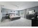Spacious main bedroom with a calming gray color palette, ceiling fan, and large window at 4422 Evergreen Forest Loop, Kissimmee, FL 34758