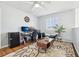 Well-lit office space with a desk, computer setup, modern mini-fridge, and stylish decor at 4422 Evergreen Forest Loop, Kissimmee, FL 34758