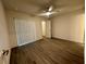 This spacious bedroom features a ceiling fan, wood-look flooring, and a walk-in closet at 1251 Dosseywood Ln, Lakeland, FL 33811