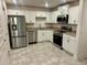 Modern kitchen featuring stainless steel appliances, light cabinetry, and neutral countertops at 1251 Dosseywood Ln, Lakeland, FL 33811