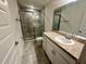 Bathroom features a tiled walk-in shower and granite counters on the vanity at 1253 Dosseywood Ln, Lakeland, FL 33811