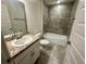Bathroom features a tiled tub/shower combo and granite counters on the vanity at 1253 Dosseywood Ln, Lakeland, FL 33811