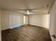 Relaxing bedroom with laminate flooring, a ceiling fan, and a sliding glass door at 1253 Dosseywood Ln, Lakeland, FL 33811