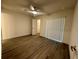 Bright bedroom features wood-look floors, ceiling fan, and a walk-in closet at 1253 Dosseywood Ln, Lakeland, FL 33811