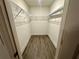 Spacious walk-in closet with modern wire shelving and wood-look flooring at 1253 Dosseywood Ln, Lakeland, FL 33811