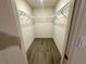 Spacious walk-in closet with modern wire shelving and wood-look flooring at 1253 Dosseywood Ln, Lakeland, FL 33811
