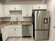 Well-equipped kitchen featuring stainless steel appliances, white cabinetry, and laminate countertops at 1253 Dosseywood Ln, Lakeland, FL 33811