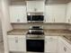 Bright kitchen with sleek stainless steel appliances, modern cabinetry, and countertops at 1253 Dosseywood Ln, Lakeland, FL 33811