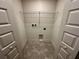 Laundry room features two doors and tile flooring at 1253 Dosseywood Ln, Lakeland, FL 33811