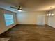 Bright living room featuring laminate wood flooring, a ceiling fan, and sliding glass door at 1253 Dosseywood Ln, Lakeland, FL 33811