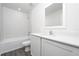 Modern bathroom featuring a tub, toilet, modern vanity, and sleek fixtures and tiled walls at 13291 Tula Loop, Astatula, FL 34705