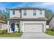 Beautiful two-story home with a well-maintained lawn, complemented by a spacious two-car garage at 13291 Tula Loop, Astatula, FL 34705