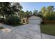 Charming single-story home featuring a well-manicured lawn, mature trees and a concrete driveway at 205 Hickory Dr, Longwood, FL 32779